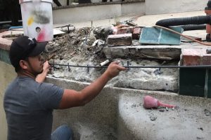 Pomona Pool Cleaning worker repairing damaged pool